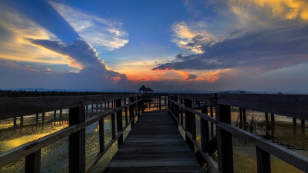 sunbeams over long boardwalk over swampland - sunbeams, clouds, arbors, boardwlk, swamp