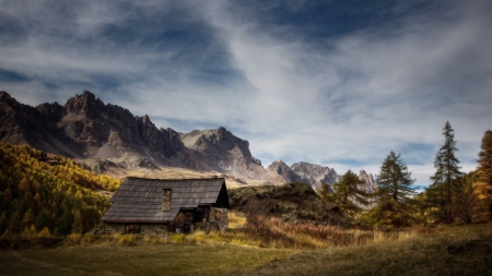 mountains above a cabin in a meadow - meadow, clouds, trees, mountain, cabin, grass