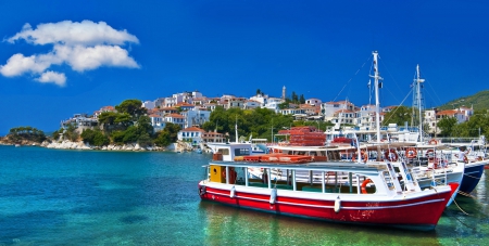 tour boats docked off greek island town - sky, town, boats, harbor, island, sea