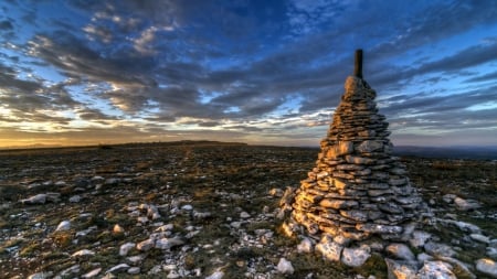 stone cone monument at dawn - clouds, cone, sunrise, meadow, rocks