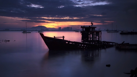 sunken boat in a malaysian harbor at twilight - boat, twilight, sunken, harbor, city