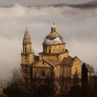 wonderful hillside italian church in fog