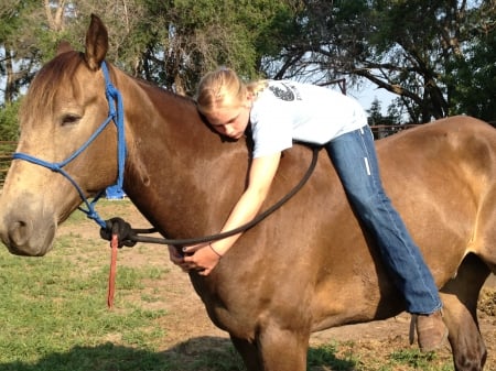 COWGIRL LOOKS LIKE SHE IS ASLEEP - brown, reins, horse, trees