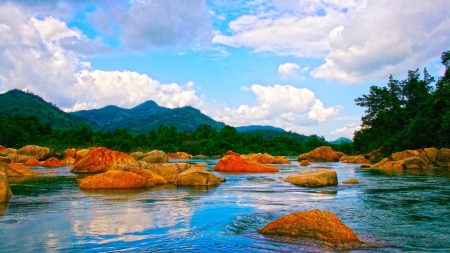 orange rocks in a flowing river - trees, flowing, river, clouds, mountains, rocks