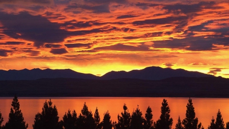 mountains silhouettes on beautiful sunset - lake, trees, mountains, wallpaper, sunset, nature, silhouettes, oceans, clouds, sunsets, orange, new