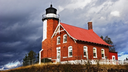 eagle harbor lighthouse on lake superior in michigan - fence, brick, lighthouse, clouds