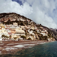 cloud covered positano on the seaside