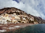 cloud covered positano on the seaside