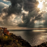 villlage on a seaside ravine under sunbeams