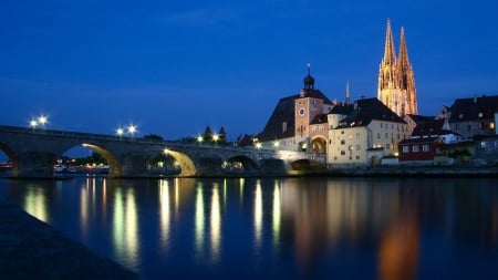 stone bridge over the danube in regensburg germany - river, lights, city, night, church, bridge