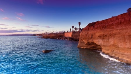 lovely sandstone coastal cliffs - sky, trees, town, cave, sea, coast, cliffs