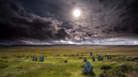 a field of stones under midday sun - prairie, clouds, field, stones, sun, grass