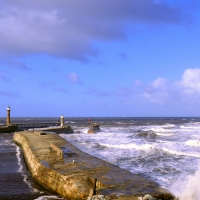 beacons on cement wharf holding back the sea