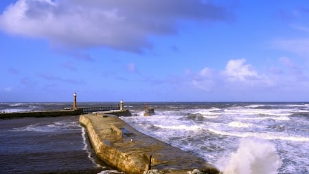 beacons on cement wharf holding back the sea - beacons, rough, sea, wharf, waves