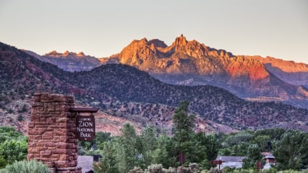 leaving beautiful zion national park in utah - sign, desert, bushes, mountains, park