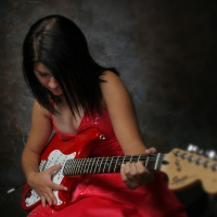 Girl in red playing guitar