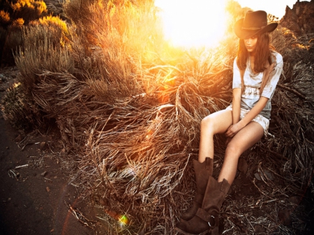 Cowgirl Sitting In A Sunset - style, fun, models, westerns, female, fashion, boots, cowgirls, hats, outdoors, sunsets