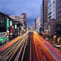 lights in long exposure on a city street in japan