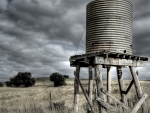 field water tower under stormy sky hdr