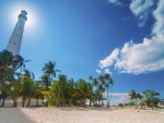 tall lighthouse on a tropical beach