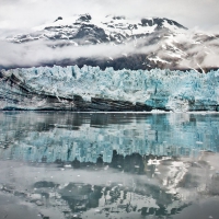 mountain glacier reflected in the bay