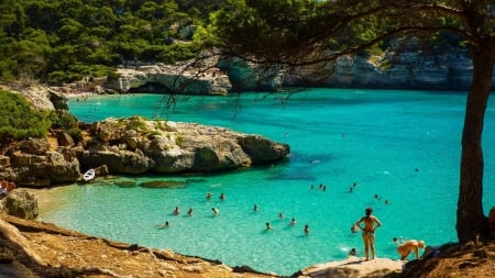 people swimming in a wonderful sea cove