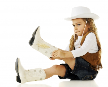 young girl trying on new boots - young, adorable, childhood, cowgirl, cute