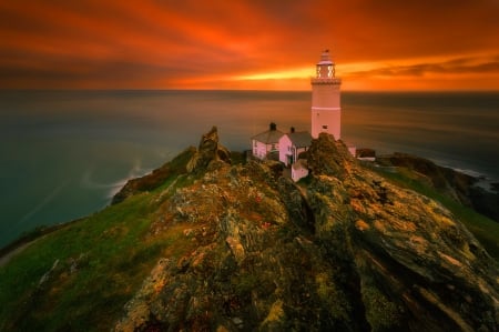 Lighthouse at sunset - clouds, coast, lighthouse, amazing, beautiful, sea, ocean, lovely, fielry, sunset, nature, view, wm dusk, houses, sky, rocks