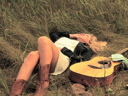 Cowgirl Lying In A Field - famous, fields, style, fun, models, guitar, westerns, female, fashion, cowgirls, boots, outdoors, country, ranch