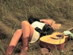 Cowgirl Lying In A Field