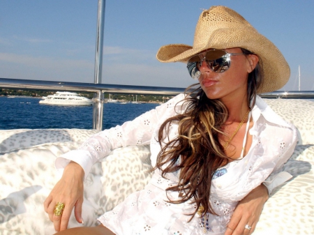 Cowgirl~Victoria Beckham - ocean, boats, hat, victoria beckham, cowgirl, spice girls, rings, necklace, water, sunglasses, singer, model, businesswoman, brunette, fashion designer, boat