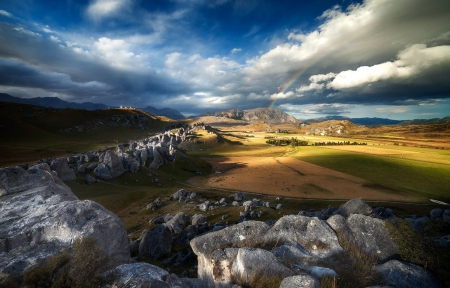 End Of The Rainbow - clouds, prairie, beautiful, mountain, rainbow, New Zealand, field, sky, rocks