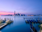 boat piers across the lagoon from venice at sunset