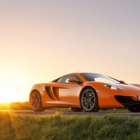 sunrise over an orange mclaren mp4 12c