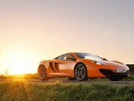 sunrise over an orange mclaren mp4 12c