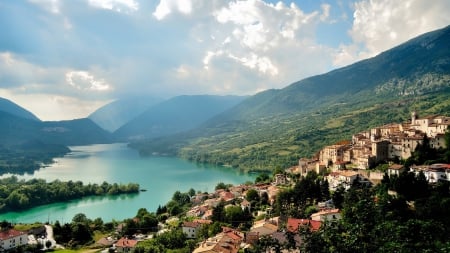 marvelous hillside town above a lake - hill, lake, town, clouds, mountains