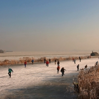 people ice skating on a river in holland hdr