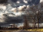 superb clouds over countryside road hdr