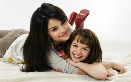 Selena Gomez with a cute kid. - beautiful, long black hair, singer, people