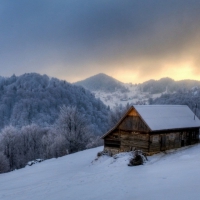 wooden mountain cabin in winter hdr