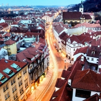 lit street in prague at dusk