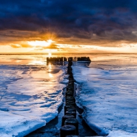 ice on seashore at sunset