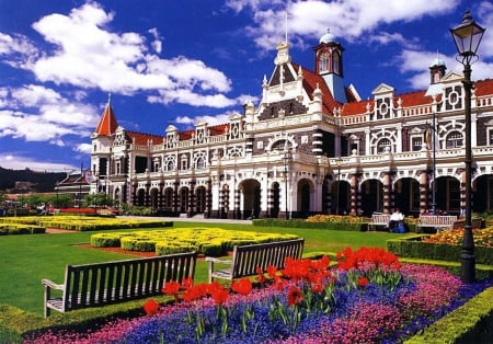 Dunedin Railway Station - impressive, benches, building, flowers, parg, colors