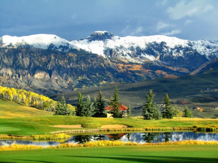 Mountain village - quiet, hills, landscape, grass, reflection, mountain, calmness, cliffs, lake, houses, sky, beautiful, snowy, pond, peaks, village, nature, serenity, peaceful, rocks