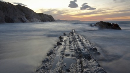 rock like an alligator's back on seashore - sea, shore, sunset, rocks