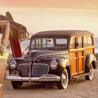 A Woody, Beach, Surfboard and a Bikini Model