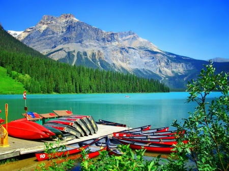 Emerald lake - hills, beautifuyl, forest, mountain, shore, view, peak, cliffs, lake, emerald, sky, trees, lovely, dock, pier, boats, nature, serenity