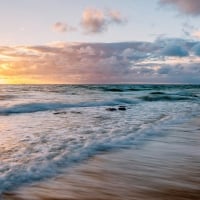 tranquil waves on a beach at sunset