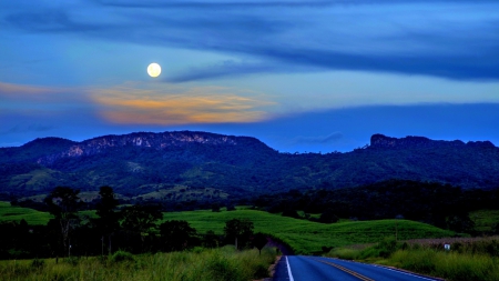 highway to mountains under moonlight - moon, highway, trees, blacktop, grass, mountains