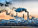 smoking stacks above a factory hdr